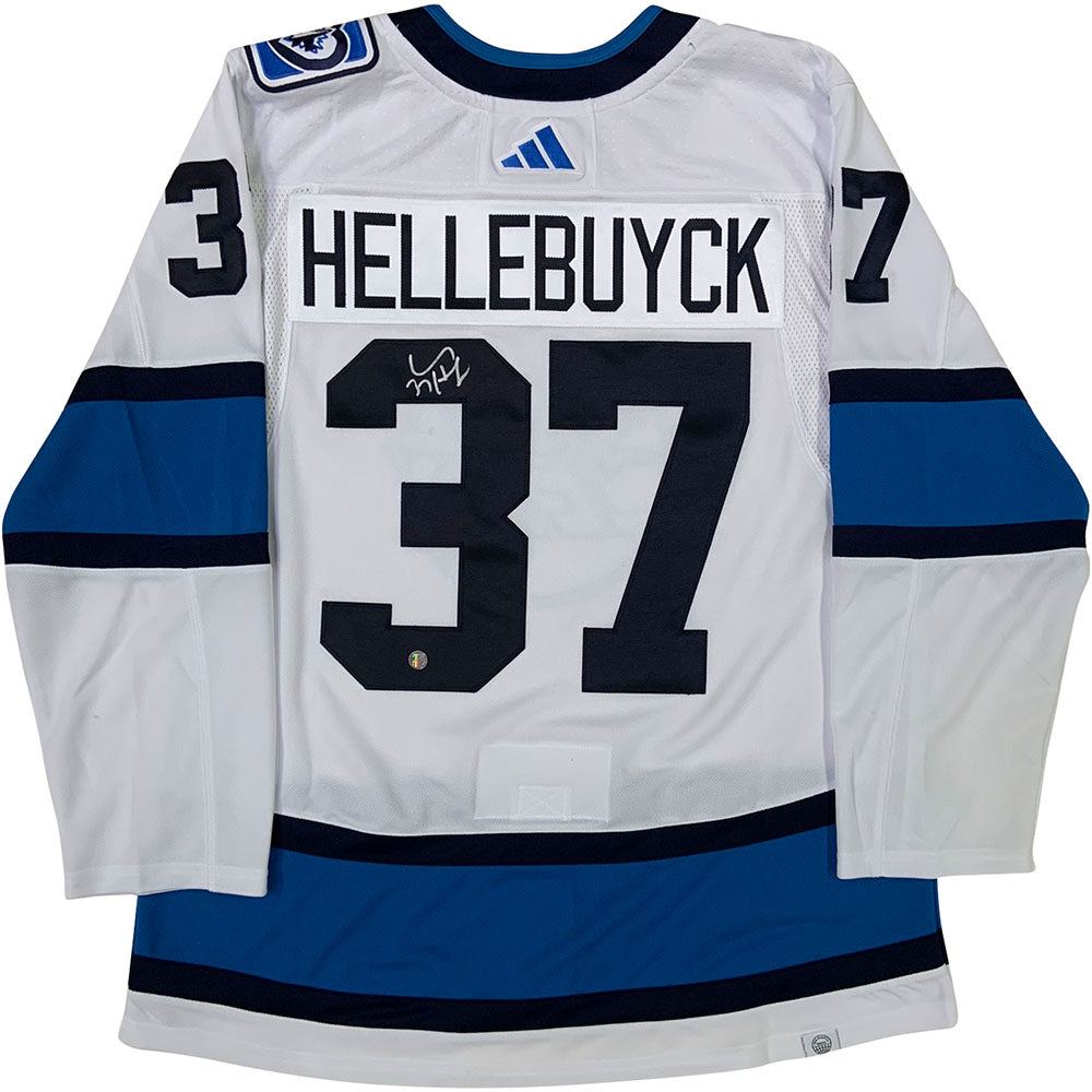 Connor Hellebuyck Winnipeg Jets Unsigned Reverse Retro Jersey in Net Photograph